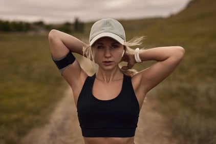 Fit woman with sportwatch and cap